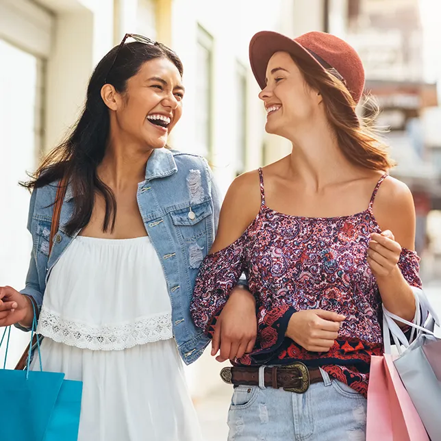 two young women carrying shopping bags