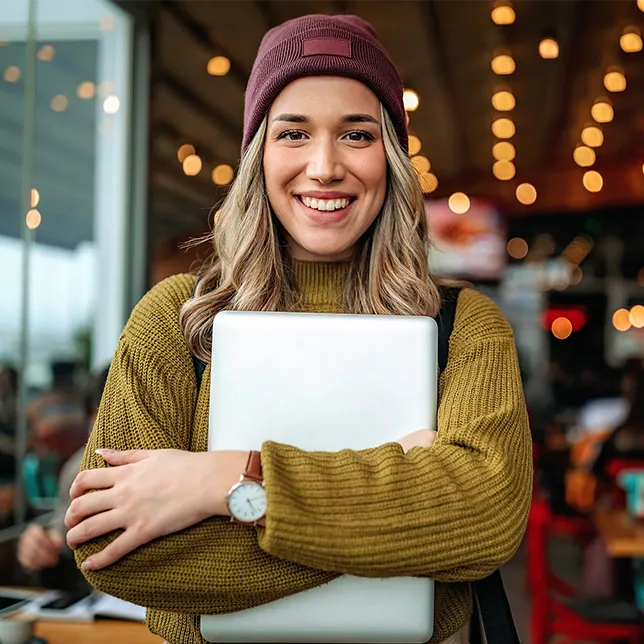 young woman holding a laptop